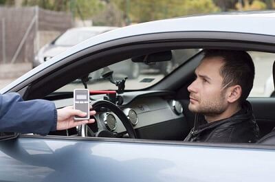 Officer asking a person to take a breathalyzer test